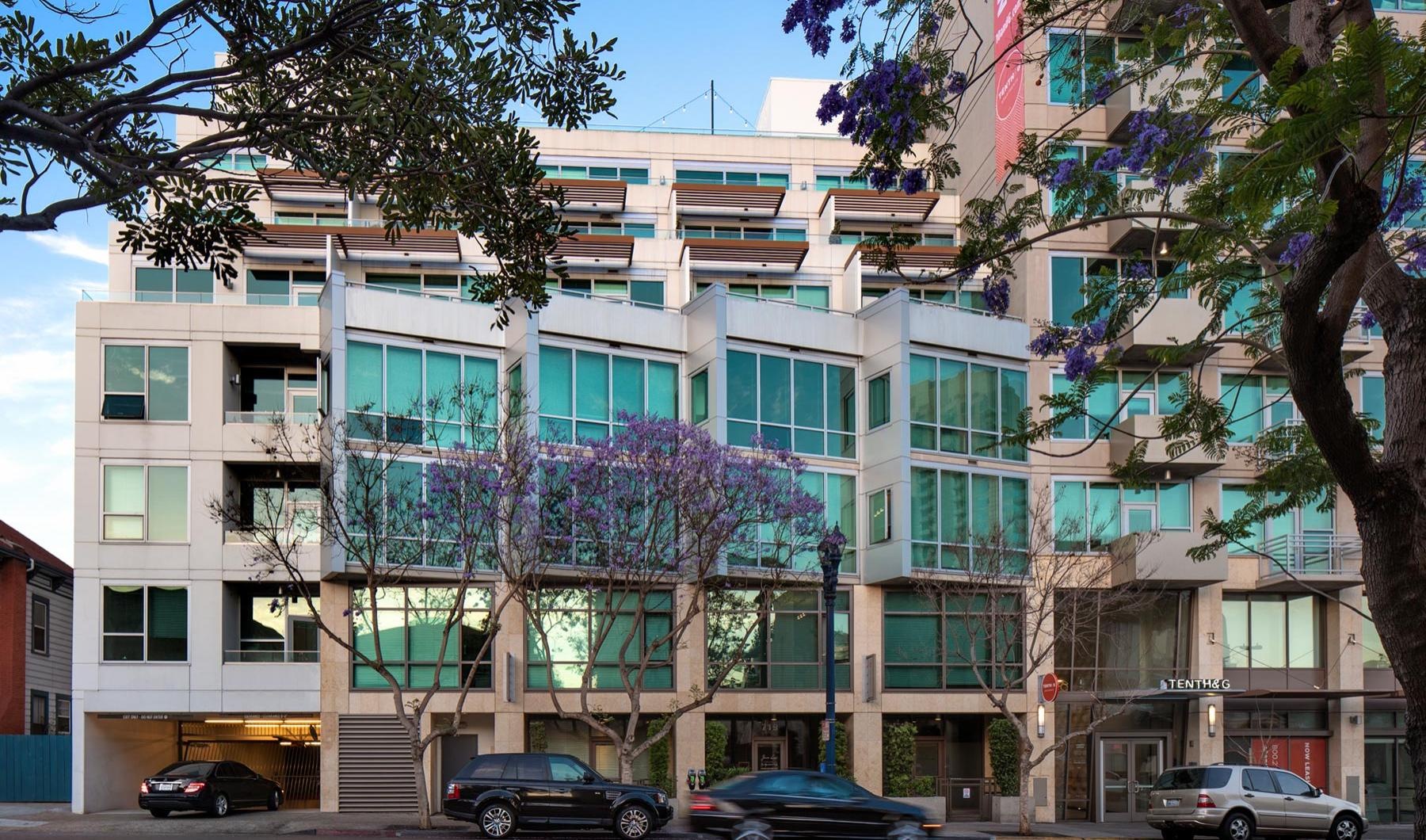 a building with trees and cars in front of it