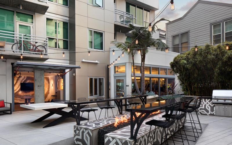a courtyard with tables and chairs outside a building