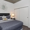 a bedroom with a bed and two nightstands
