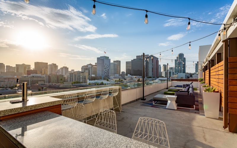 a rooftop courtyard with tables and chairs
