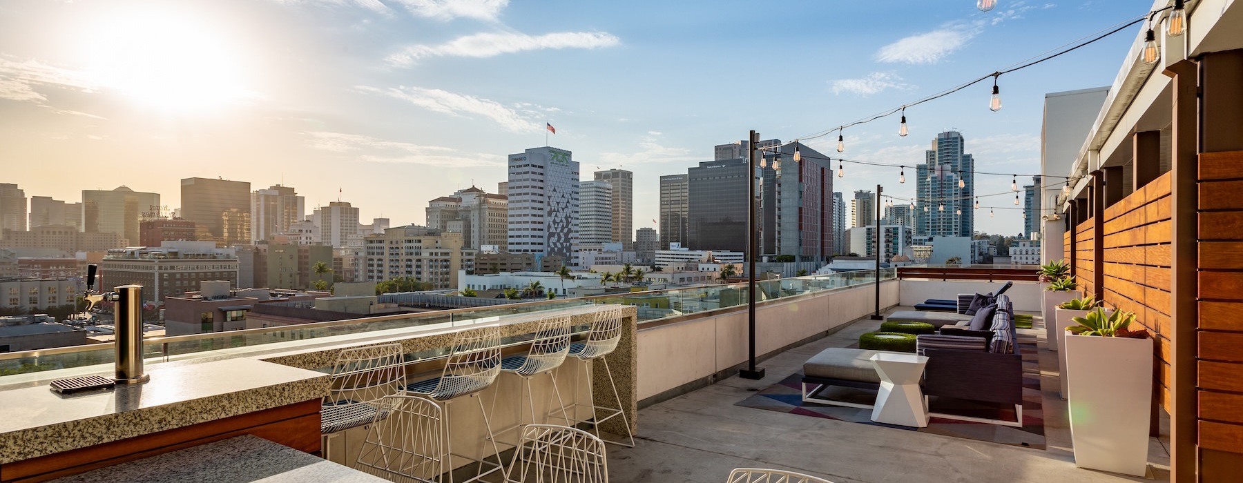 a rooftop courtyard with tables and chairs
