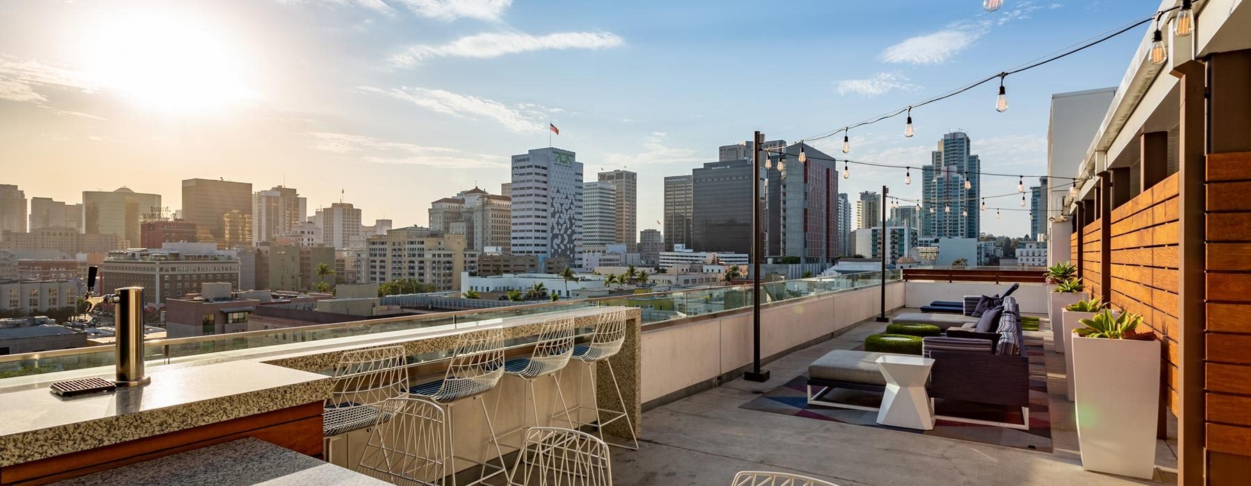 a rooftop lounge area with furniture