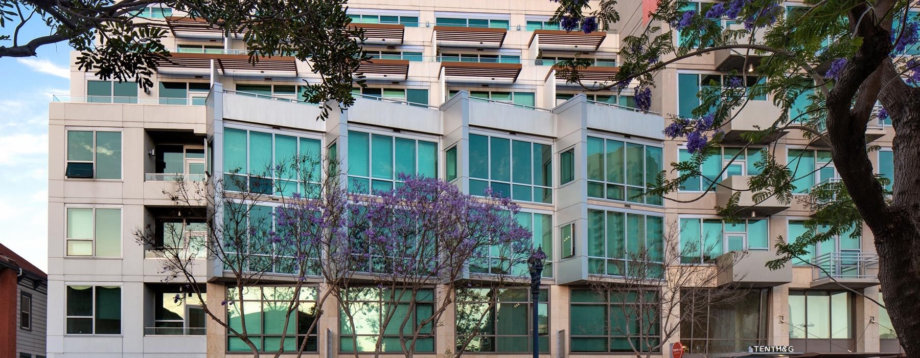 a building with trees and cars in front of it