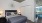 a bedroom with a bed and lamps